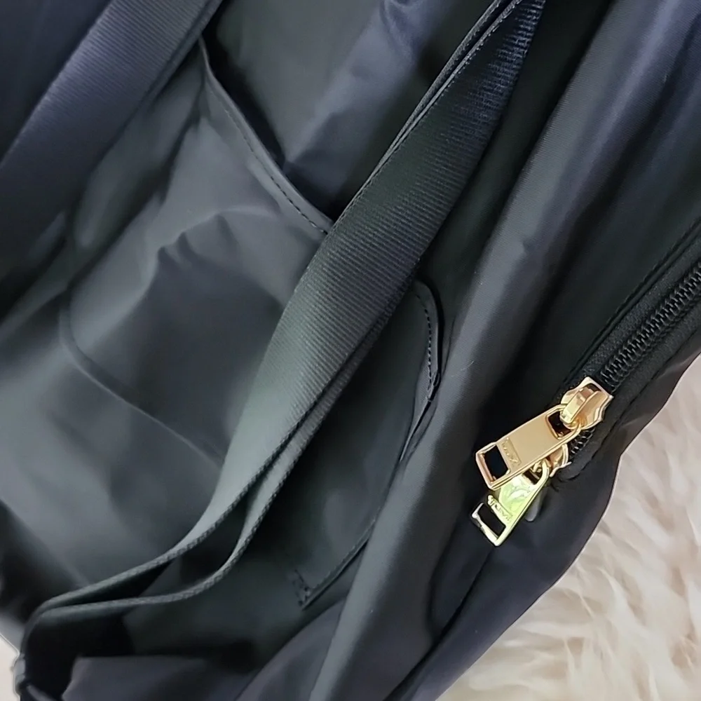 NWOT Tumi Just in Case Backpack in Black and Gold
